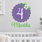 Purple and green 4-month wall decal with scalloped circle, flower accents, and number 4