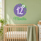 12-month wall decal with purple “12” and green floral border and “Months” text