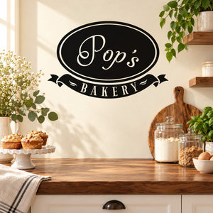 Pop's Bakery oval wall decal with "Pops" and "Bakery" in white on black