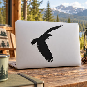 Black bald eagle flapping decal sticker, spread-wing silhouette on white surface