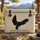 Beige cooler with black bald eagle decal