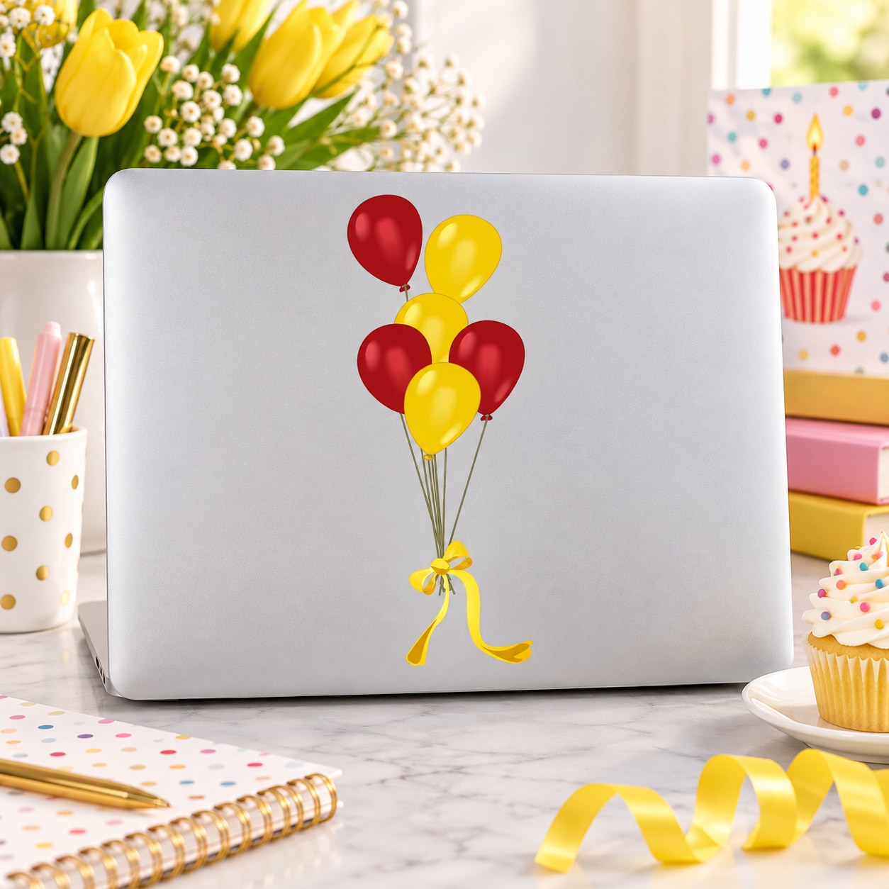 Balloon sticker with red and yellow tied balloons and ribbon on white laptop