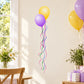 Yellow and purple balloon sticker with dangling ribbon streamers