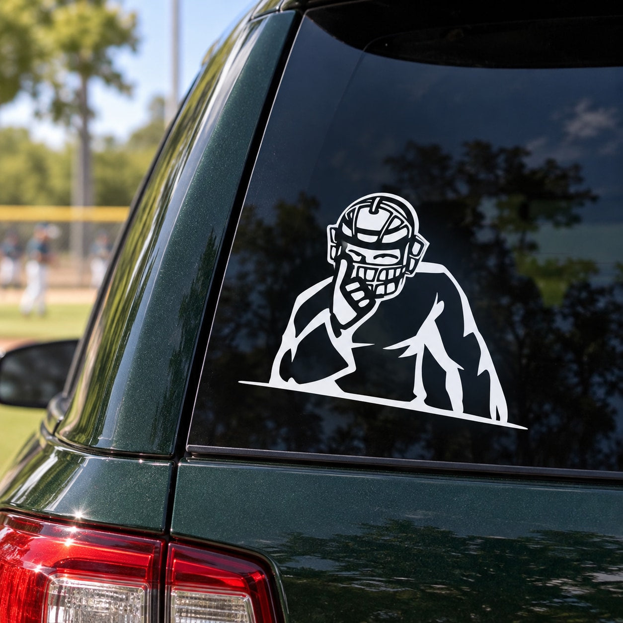 Baseball catcher decal featuring white helmeted catcher graphic on car window