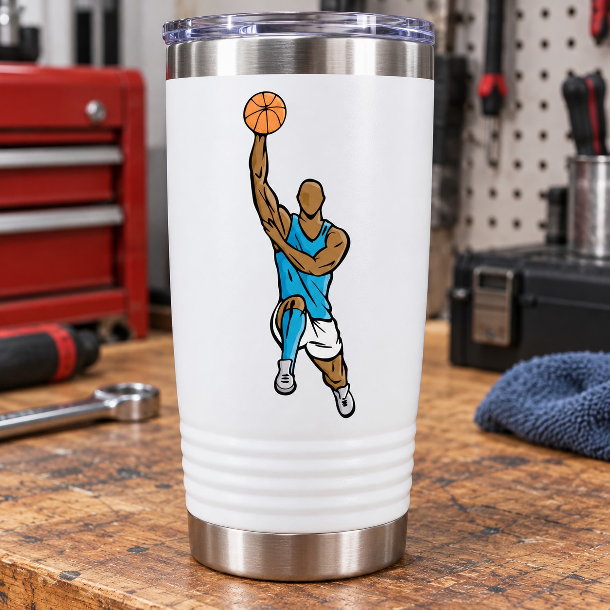 Basketball player vinyl decal sticker on tumbler-style cup, blue uniform and orange ball