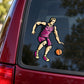 Basketball player vinyl sticker, purple jersey dribbling an orange basketball on window