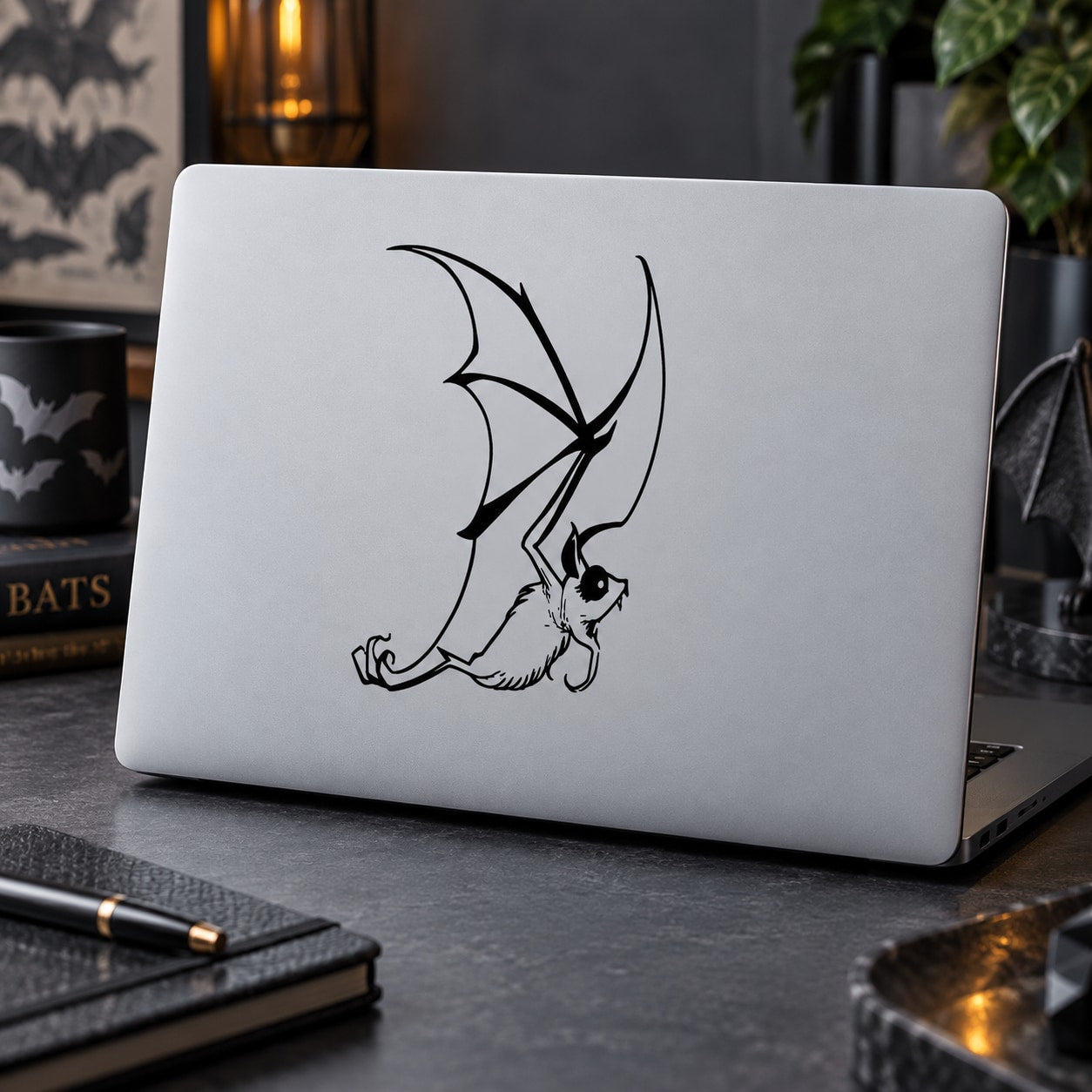 Fluttering bat decal with black line-art bat and wings on a light surface