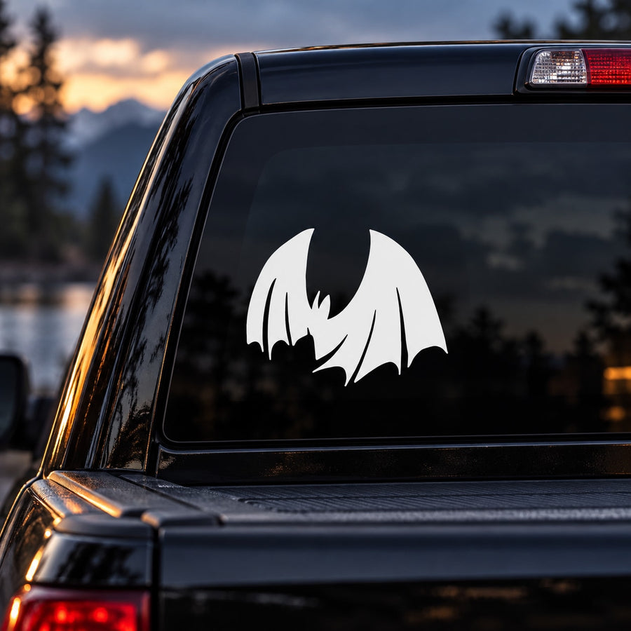White descending bat silhouette decal on dark car window glass