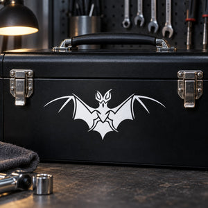 White bat wing decal for dark surface, spread-wing graphic centered on a toolbox