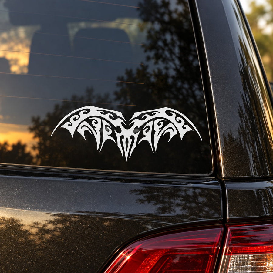Tribal bat graphic decal with black-and-white symmetrical wings on car panel