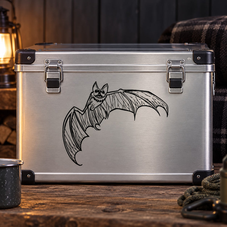 Carved bat decal with wings spread, black bat silhouette on a metallic surface