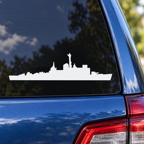 White destroyer ship silhouette decal on blue car panel near rear taillight