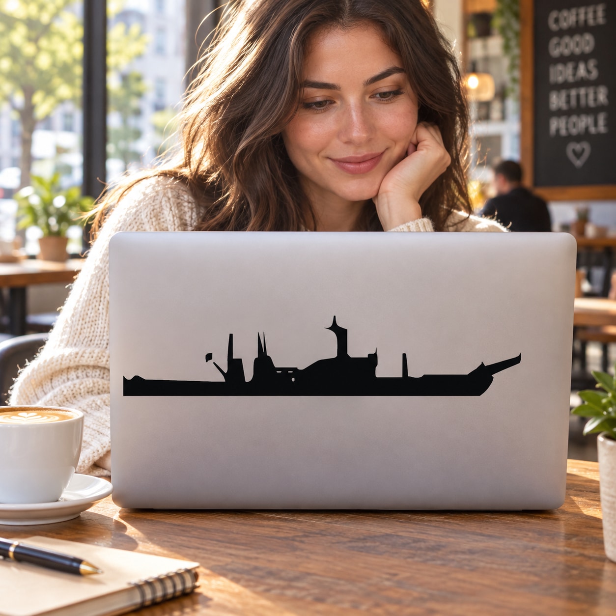 Black battleship silhouette decal on a laptop lid