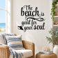 “The beach is good for your soul” black wall decal text with small beach icon