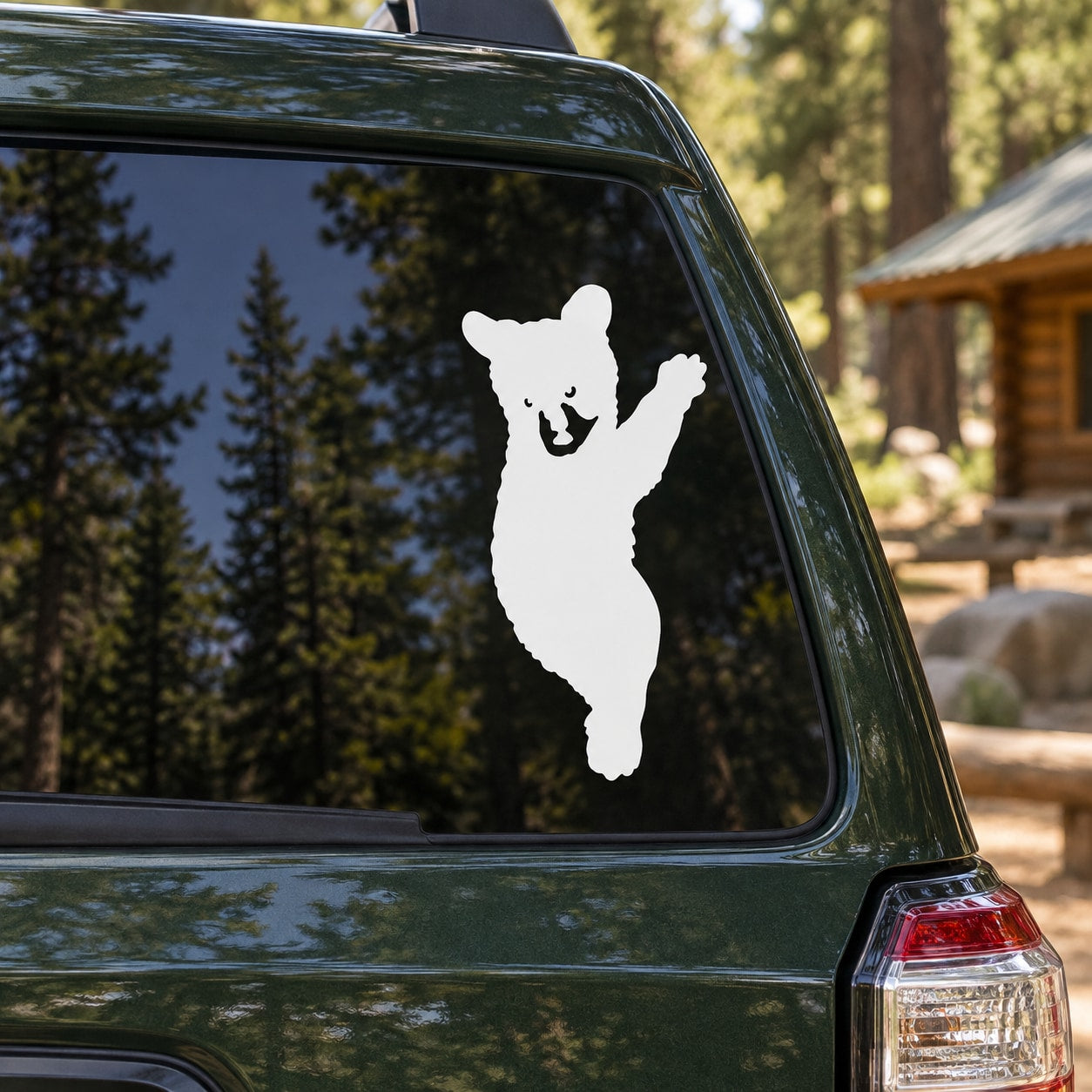 Climbing bear cub decal, white silhouette on car window glass