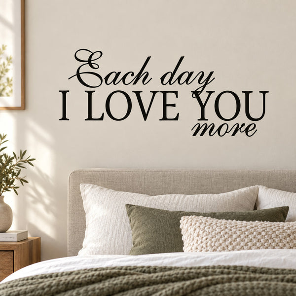 Wall decal with black text: 'Each day I LOVE YOU more' and heart flourish