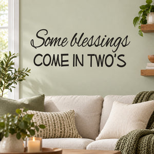 Black wall decal with script and bold text: "Some Blessings Come In Twos"