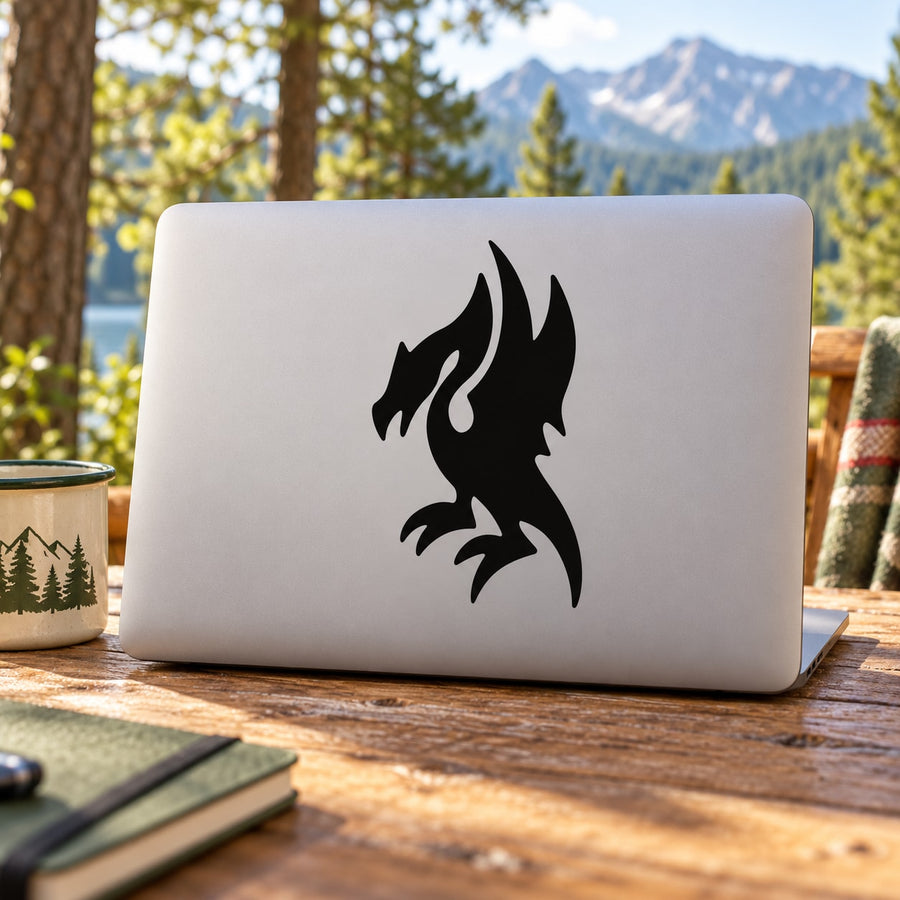 Black perched dragon decal on a light laptop lid