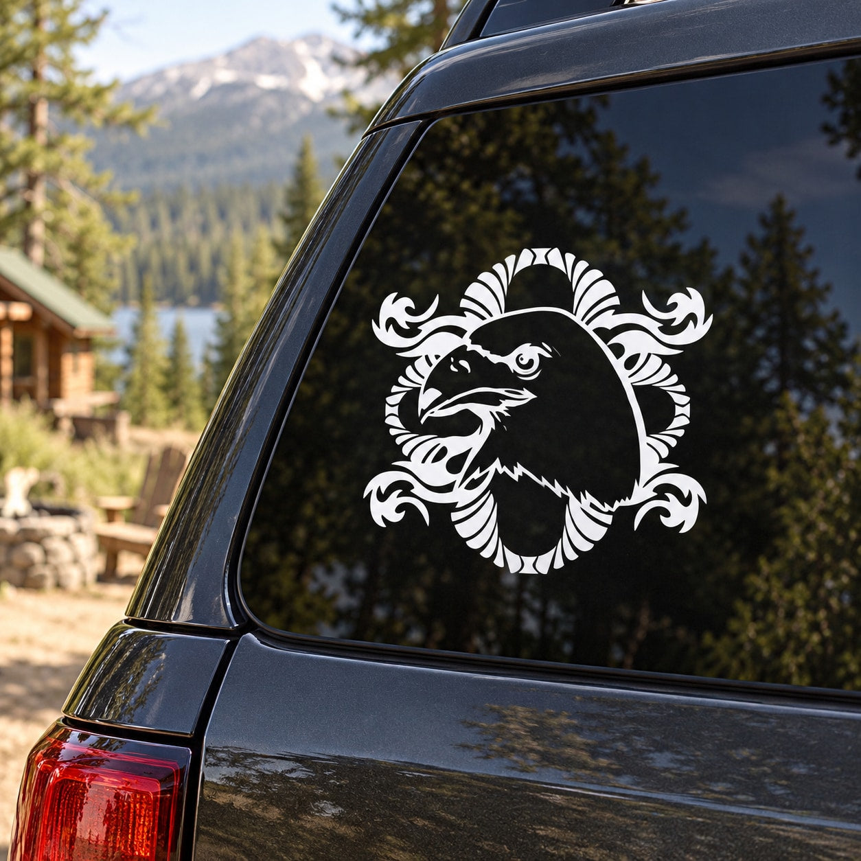 White fancy eagle head decal with ornate frame on dark car window