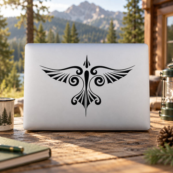 Black ornate eagle swirl decal on white laptop lid
