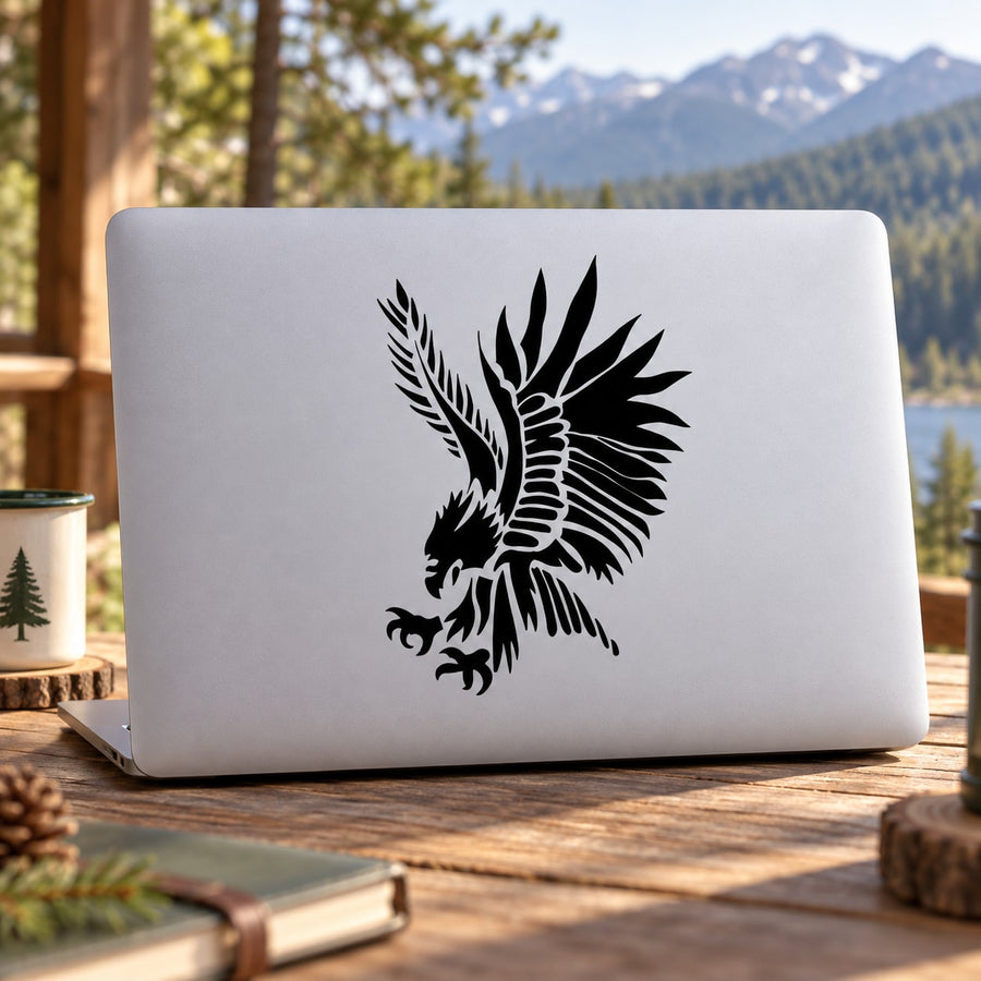 Black native wild eagle hunting decal with detailed wings and feathers on a light laptop lid