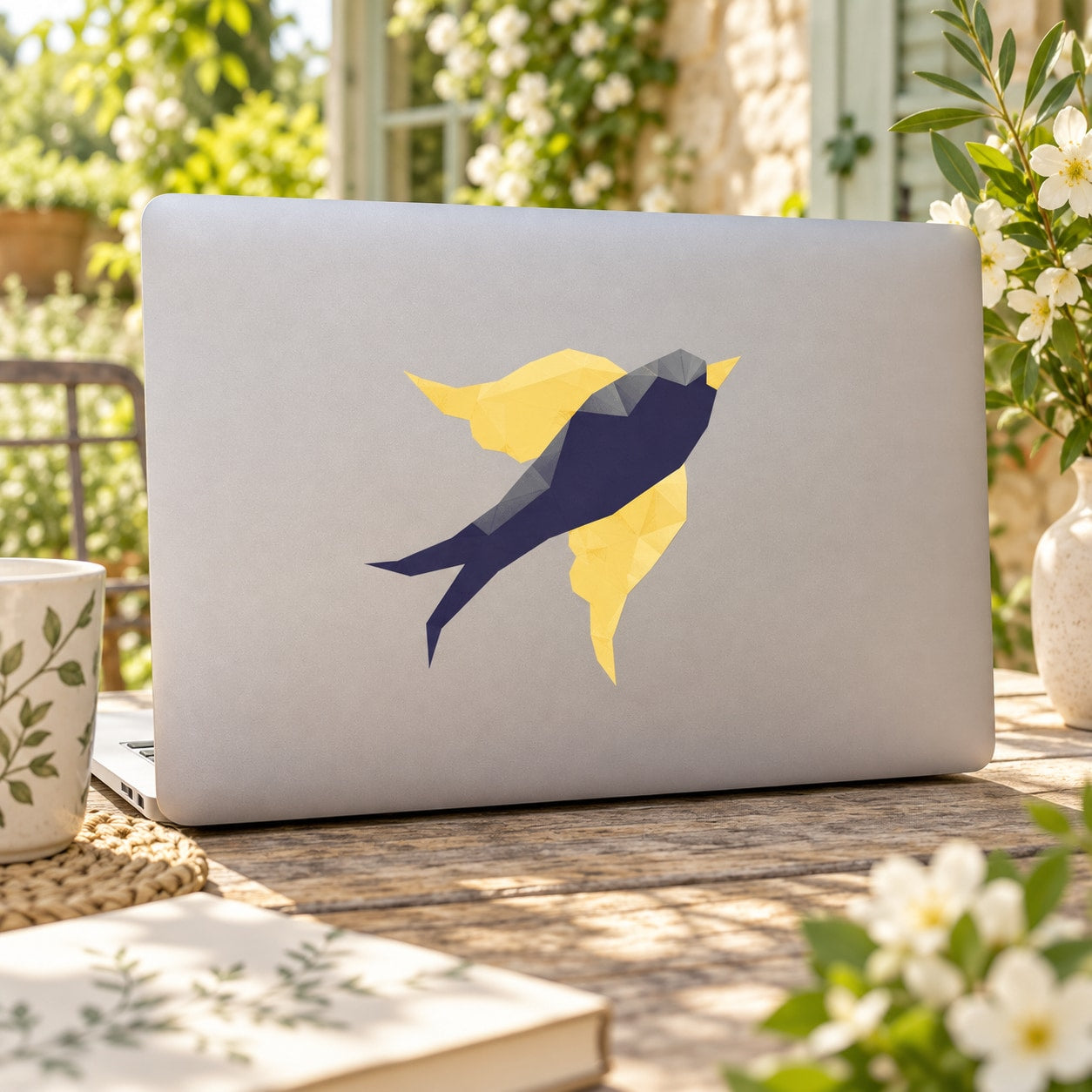 Geometric flying bird sticker with yellow and dark blue shapes on a light surface