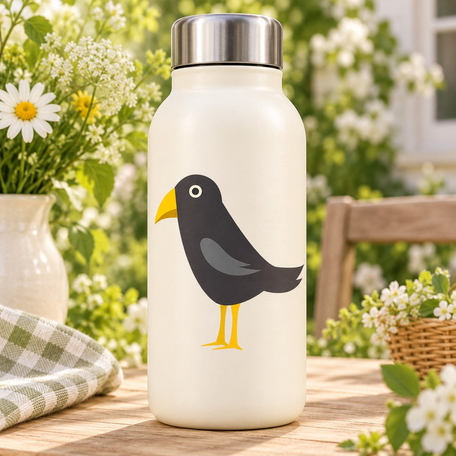 Crow bird sticker, black body with yellow beak and feet on white bottle