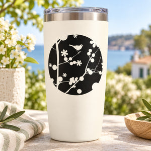White tumbler with black circle bird and floral decal