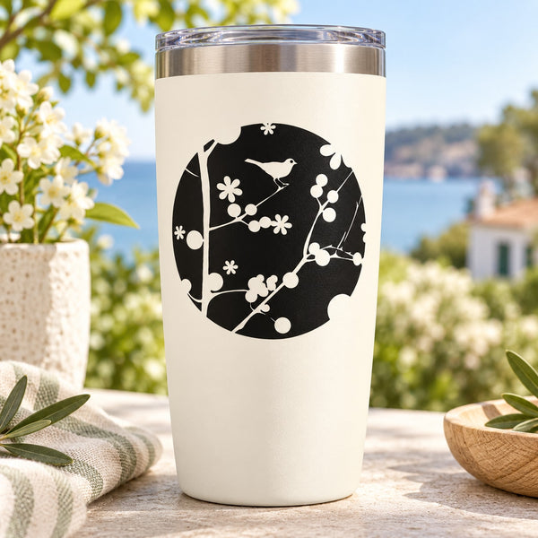 White tumbler with black circle bird and floral decal