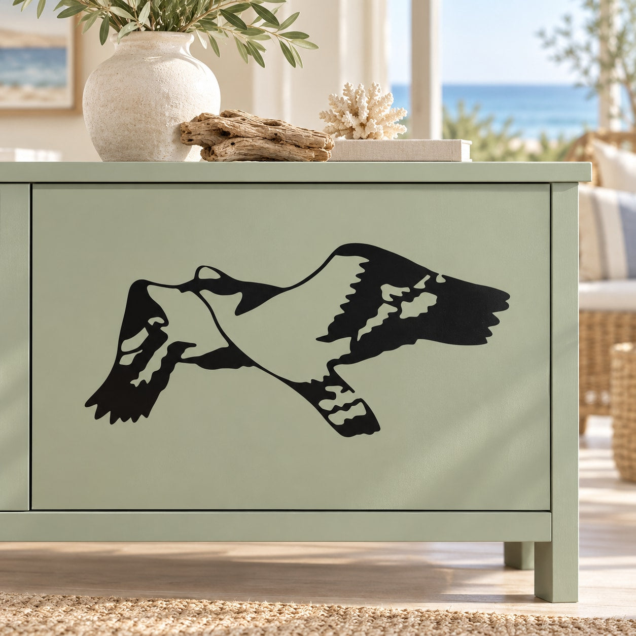 Seagull decal sticker with black bird silhouette on light green cabinet drawer front
