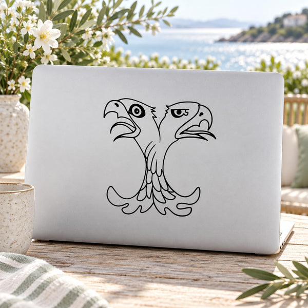 Double-headed eagle decal with line-art faces, black on light background