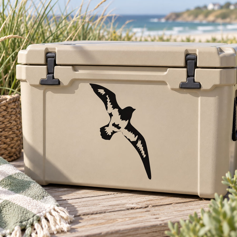 Flying shore bird decal sticker in black on a light beige cooler
