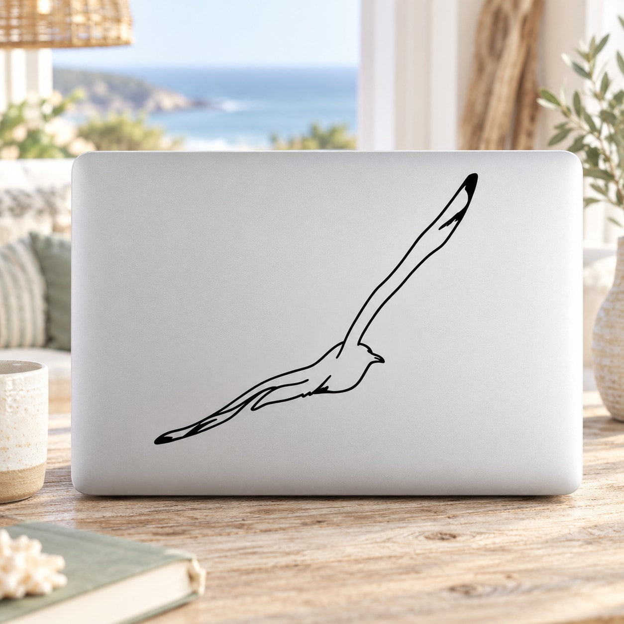 Flying seagull line-art decal with black outline on white surface