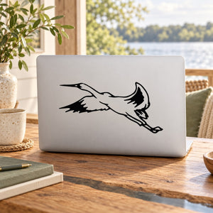 Black flying bird silhouette decal on white laptop skin