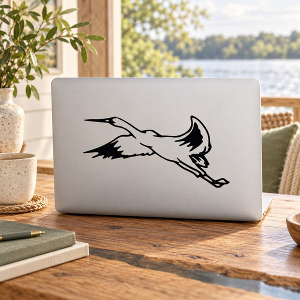Black flying bird silhouette decal on white laptop skin