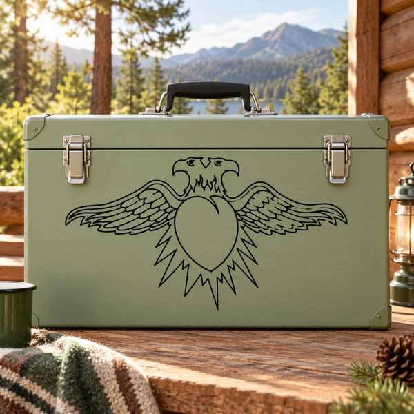 Double-headed eagle and heart decal, black line art on green surface