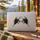 Perched eagle decal with black mirrored wings on a light gray laptop