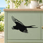 Black chirping swallow wall decal on a light green cabinet drawer