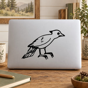 Baby woodpecker decal: black bird outline on light gray laptop lid