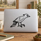 Baby woodpecker decal: black bird outline on light gray laptop lid