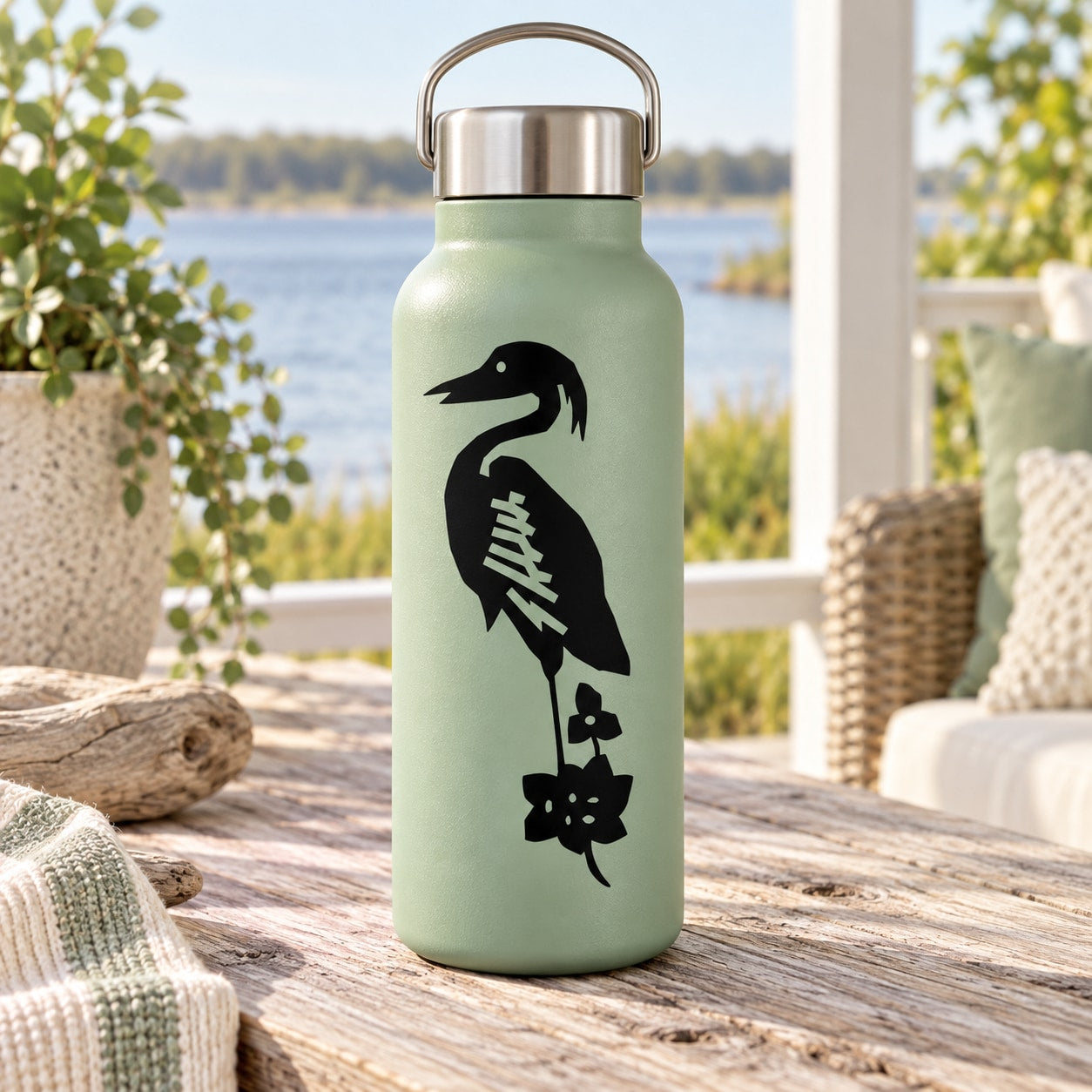 Mint green water bottle with black heron decal and carry handle