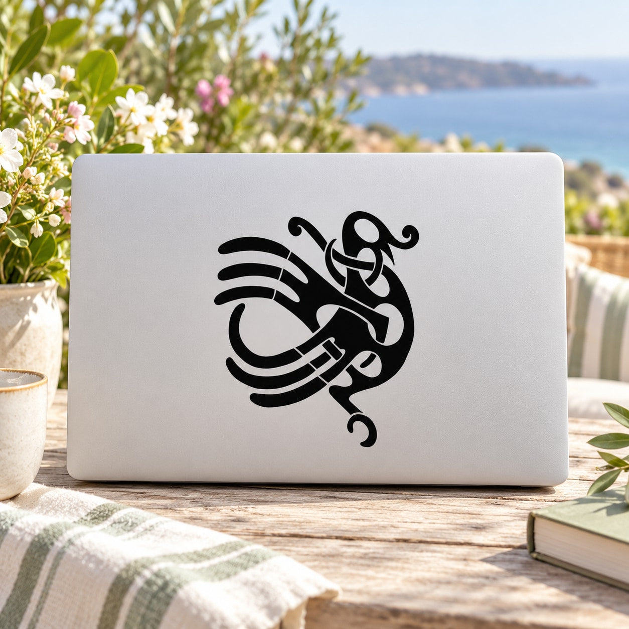 Black Celtic abstract bird decal on a rectangular white surface