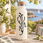 Clear bottle with black abstract bird decal on front