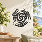 Interlocking eagle decal with black circular swirl design on light fabric