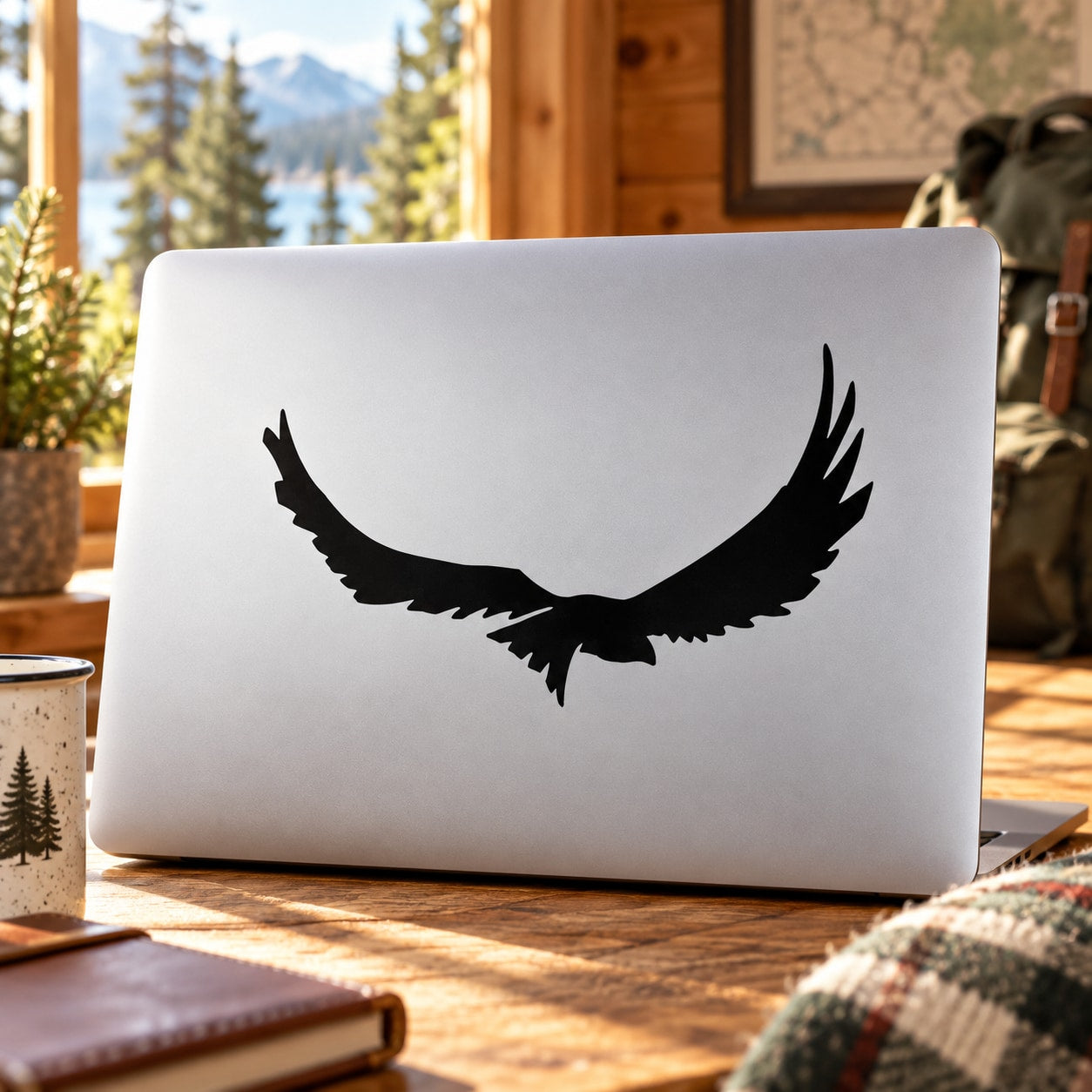 Flying Hawk decal with black hawk silhouette on white laptop lid