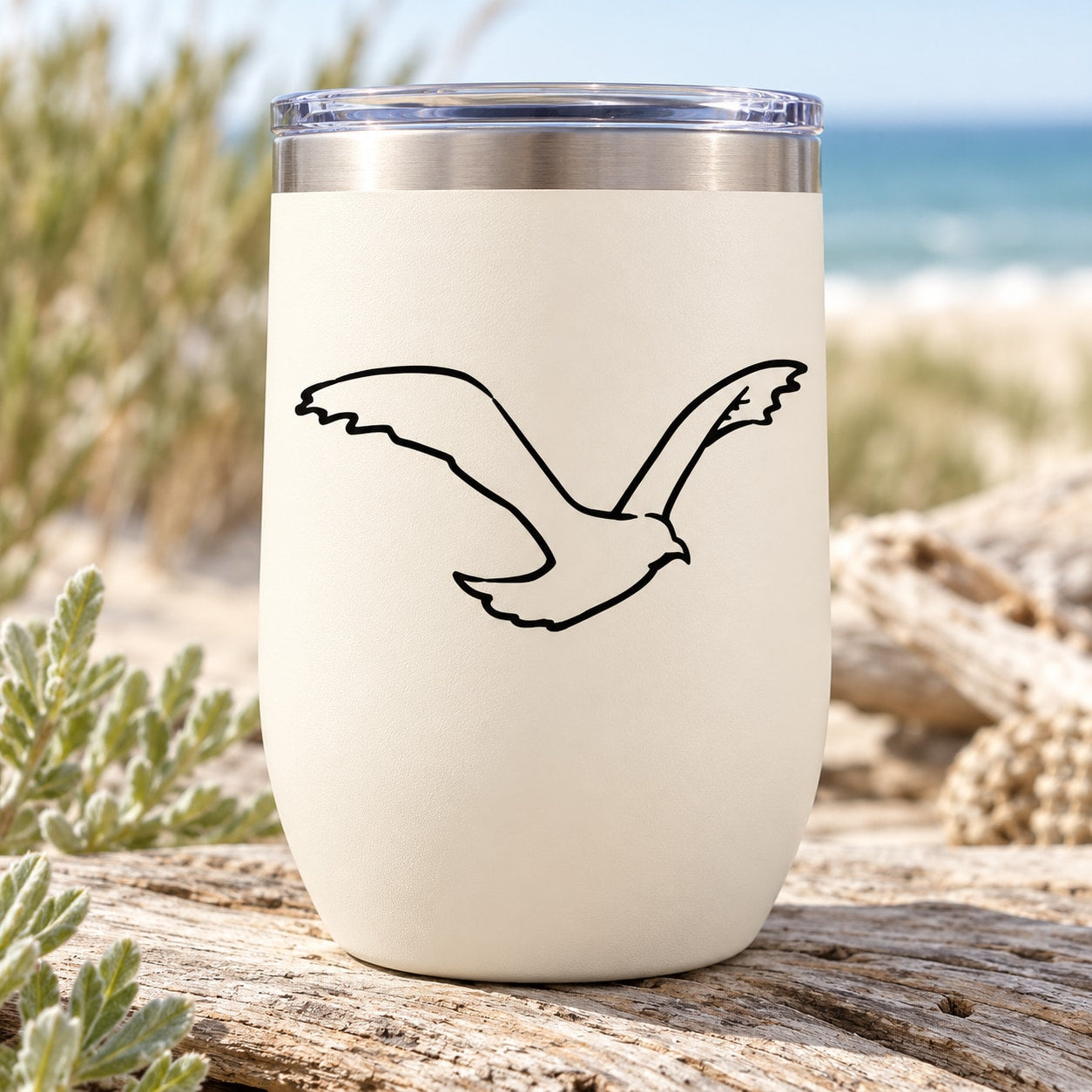 White tumbler with black flying bird decal on front