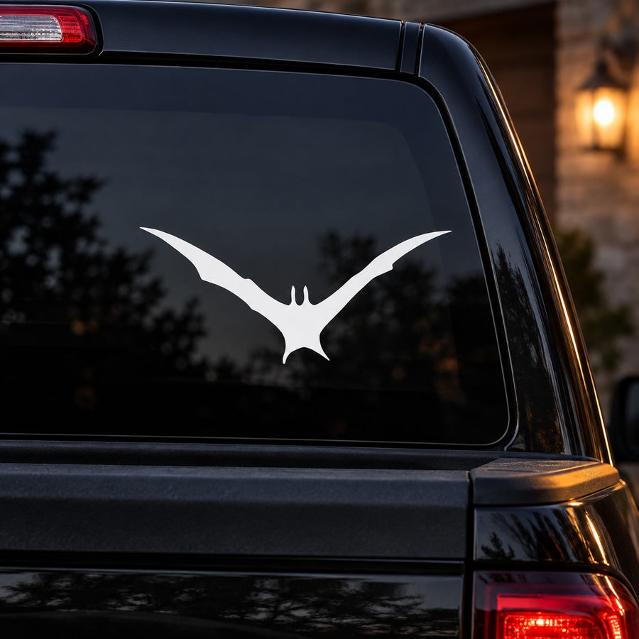 White flying bat decal on car window