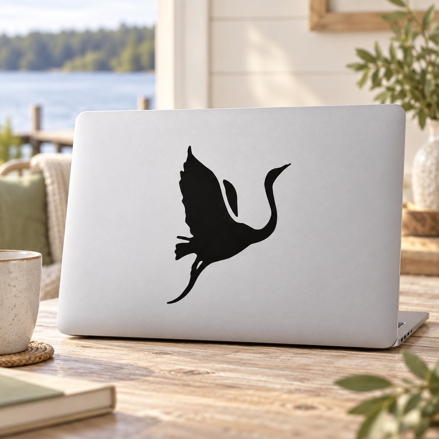 Black flying swan vinyl decal sticker on a laptop lid