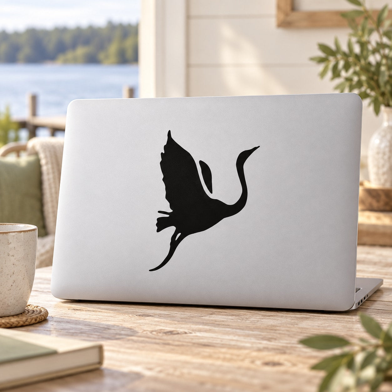 Black flying swan vinyl decal sticker on a laptop lid
