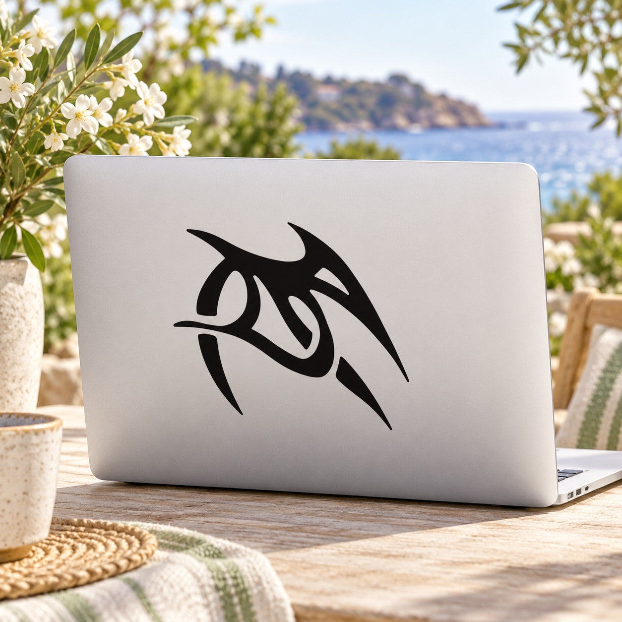 Black swooping abstract bird decal on light gray laptop lid